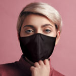 Woman wearing non-medical cloth face mask. Reusable respirators. Fashionable fabric face coverings.