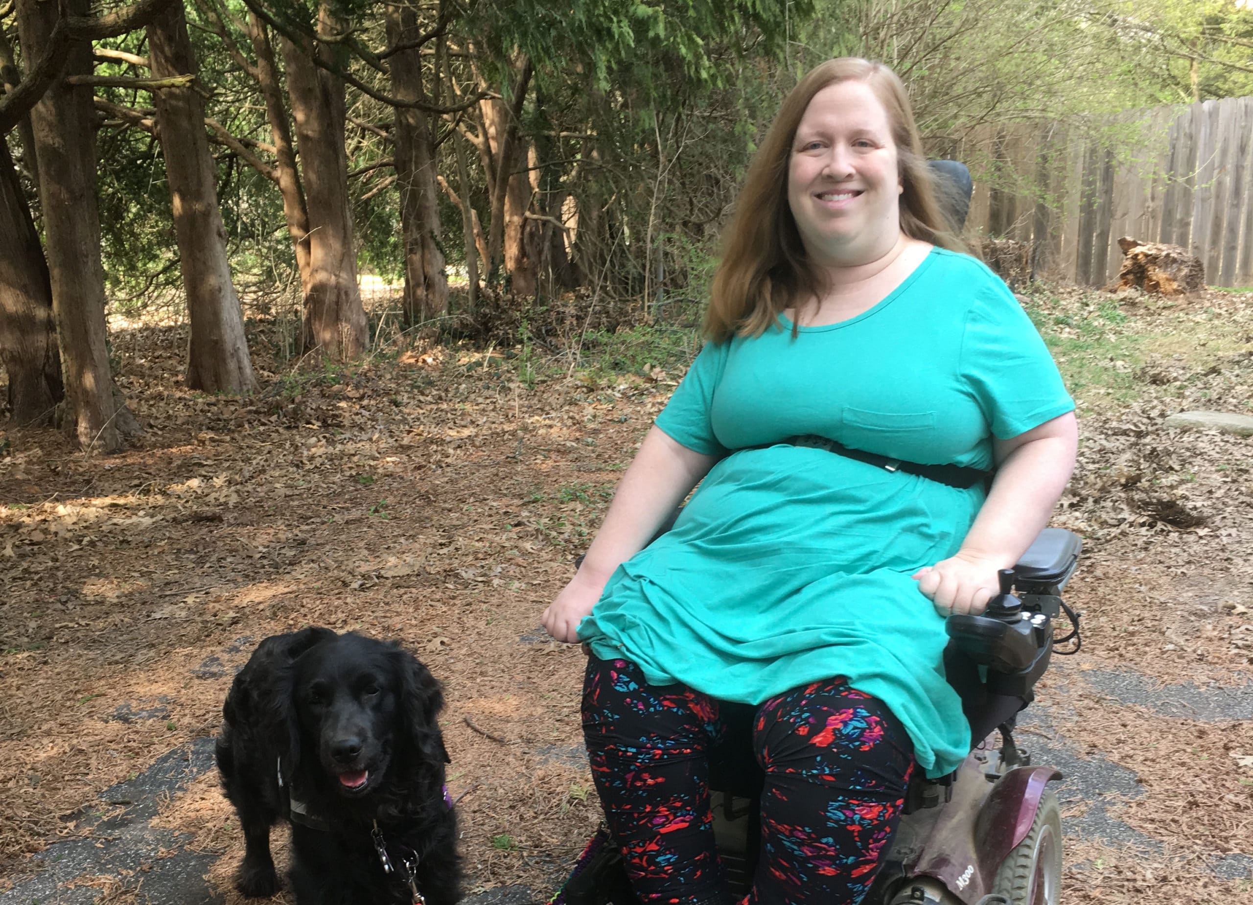 Navigating life when you need home care for a disability during COVID-19. Karin sitting outside in her wheelchair with service dog Aria.