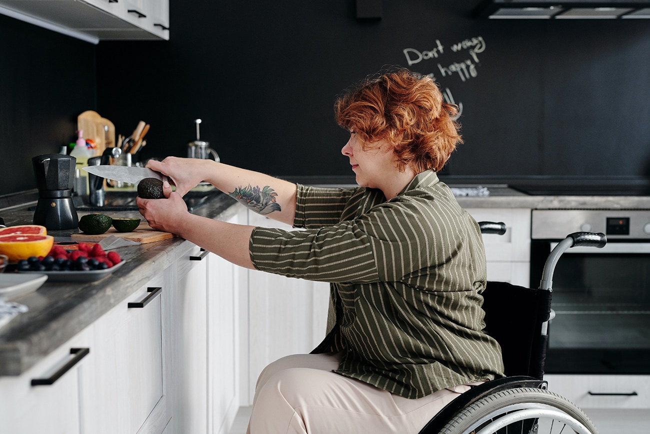 Woman in a wheelchair cooking. People with disabilities.
